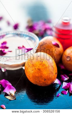 Face Pack For Cheeks On Wooden Surface Consisting Of Sapodilla Or Chikoo Well Mixed With Sandalwood