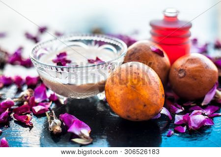 Face Pack For Cheeks On Wooden Surface Consisting Of Sapodilla Or Chikoo Well Mixed With Sandalwood