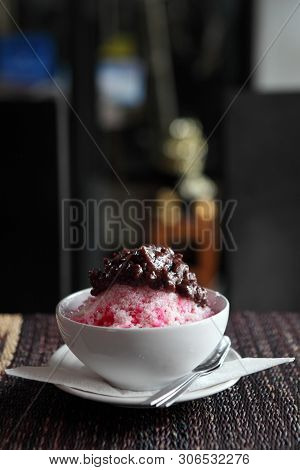Traditional Japanese Dessert , A Bowl Of Red Bean Sweet With Red Ice On Wood Pattern