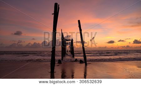 The Old Wooden Bridge And Sea Wave On The Beach At Sunset Sky Background At Khao Pilai, Phangnga, Th