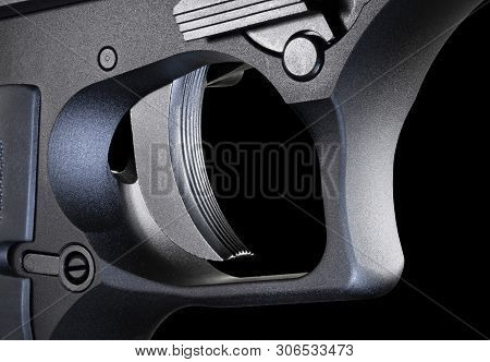 Trigger For An Automatic Pistol On A Black Background