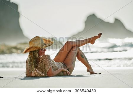 young woman relaxing on the beach in summer day