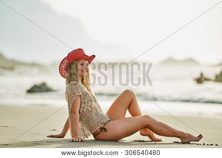 young woman relaxing on the beach in summer day