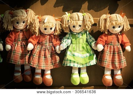 Four Rag Dolls Girls. Some Rag Dolls In A Row Seems To Be Held By Hand. Vignette With Vintage Retro 