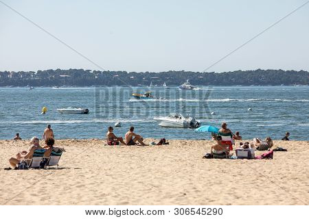 Arcachon, France - September 10, 2018: People Are Enjoying A Sunny Day On A Sandy Beach In Arcachon,