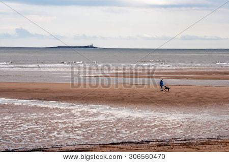 Alnmouth Beach, Northumberland, England. 11 May 2019. Alnmouth Beach With A Dog Walker With Coquet I