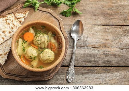 Flat Lay Composition With Jewish Matzoh Balls Soup On Wooden Table. Space For Text