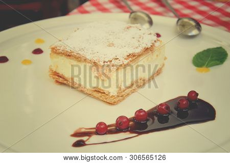 Delicious Sweet Caloric Papal Fondant Served With On White Plate With Fruit With A Silver Steel Spoo