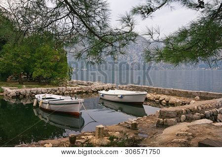 Autumn. Two Fishing Boats On The Water In A Small Harbor On A Cloudy Day. Montenegro, Adriatic Sea, 