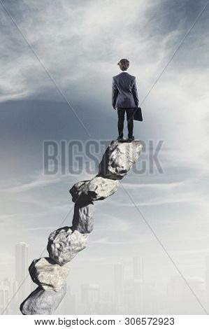 The Businessman Standing On Stack Of Stones.