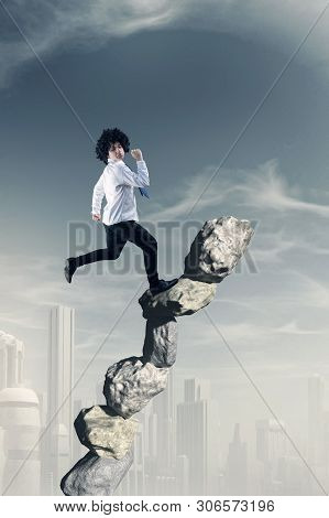 Businessman Running On A Stack Of Stones .