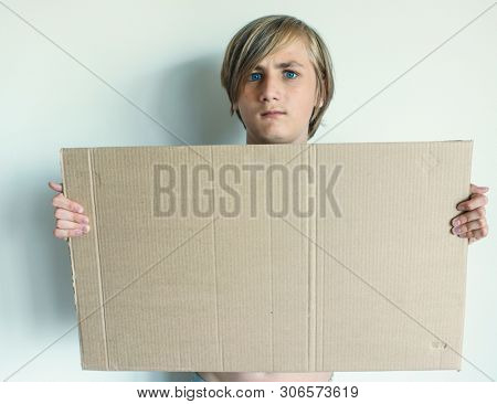 Boy Showing Blank Signboard with Empty Copyspace