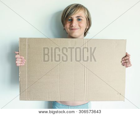 Boy Showing Blank Signboard with Empty Copyspace