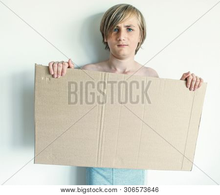 Boy Showing Blank Signboard with Empty Copyspace
