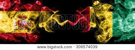 Spain Vs Guinea, Guinean Smoky Mystic Flags Placed Side By Side. Thick Colored Silky Smokes Flag Of 