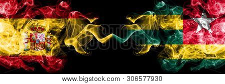 Spain Vs Togo, Togolese Smoky Mystic Flags Placed Side By Side. Thick Colored Silky Smokes Flag Of S