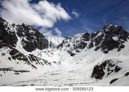 Snowy Sunlit Mountains With Traces From Avalanches And Blue Cloudy Sky In Sunny Winter Day. Turkey, 
