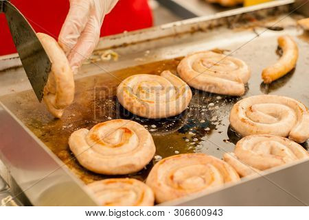 Spiral Sausages Are Fried In Butter On A Baking Sheet In A Street Cafe Close Up