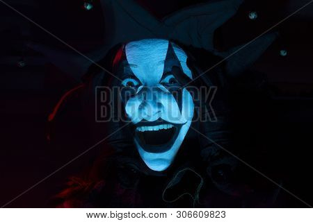 Horrible Screaming Jester's Face In Dark Room, Close-up.
