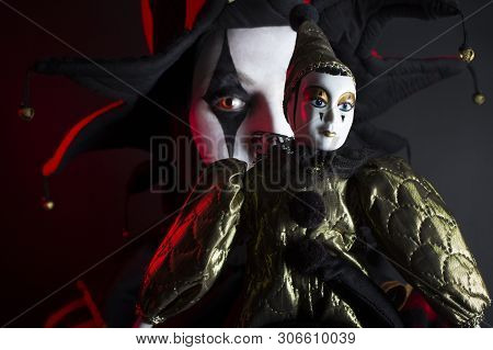 Scared Jester Woman Hiding Behing The Jester Doll.
