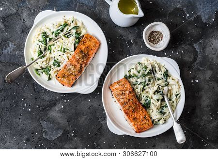 Healthy Balanced Lunch - Creamy Spinach Orzotto And Teriyaki Tray Bake Salmon On A Dark Background, 