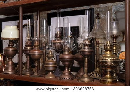 Many Kind Of Colorful Lamps On Wooden Shelf, The Paraffin Lamp Or Hand-held Lanterns Used In The Pas