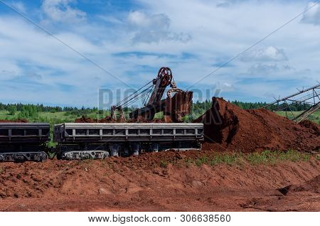 Excavator Loading Clay To The Train