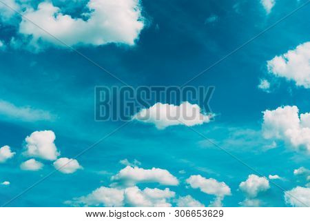 White Clouds In Turquoise Sky Background. Summertime Cloudscape Photographed In Golden Hour. Beautif
