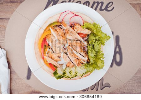 Plate With Chicken Salad On Table. Caesar Salad