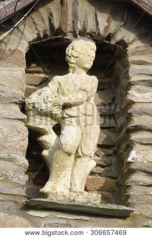 Small Statue In Wall Of Farm Building 
Trentishoe, Exmoor, Devon, Uk