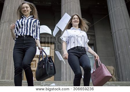 Two Young Happy Students Passed Exams And Leave Home For School, They Run Up The Stairs And Throw Aw