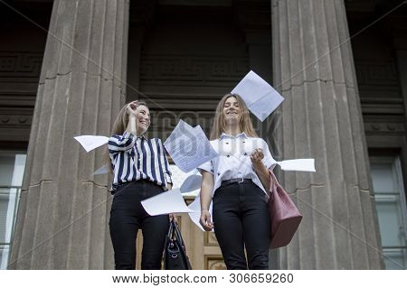 Two Young Happy Students Passed Exams And Leave Home For School, They Run Up The Stairs And Throw Aw