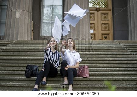 Two Young Happy Students Passed Exams And Leave Home For School, They Run Up The Stairs And Throw Aw