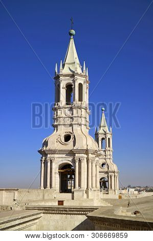 Stunning White Volcanic Stone Bell Tower Of Basilica Cathedral Of Arequipa Against Vibrant Blue Sky,