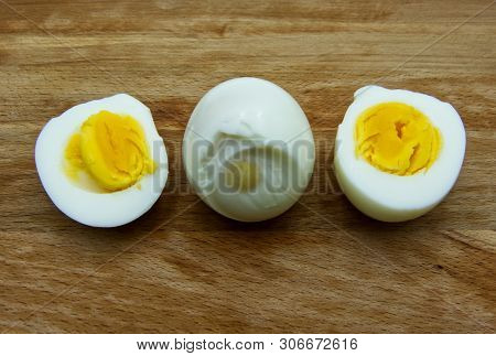 Boiled Egg With A Cut Boiled Egg On Wooden Table
