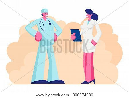Male Doctor In Medical Robe With Stethoscope Speaking With Nurse Holding Notebook In Hands, Clinic, 
