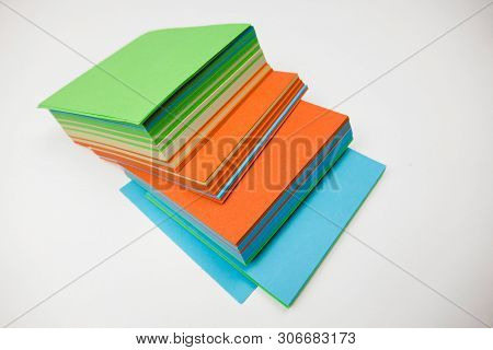A Stack Of Multicolored Note Papers On An Isolated White Background. Isolates