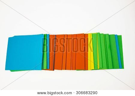 A Stack Of Multicolored Note Papers On An Isolated White Background. Isolates