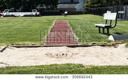 High School Long Jump, Triple Jum And Pole Vault Area Surrounded By Grass With Benches For Spectator