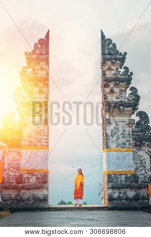 Young Woman Tourist Visiting Lempuyang Temple, Bali Indonesia. History And Religion. Sunlight
