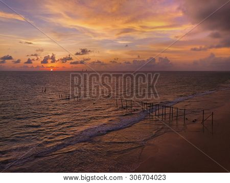 Aerial View Of The Old Wooden Bridge And Sea Wave On The Beach At Sunset Sky Background At Khao Pila