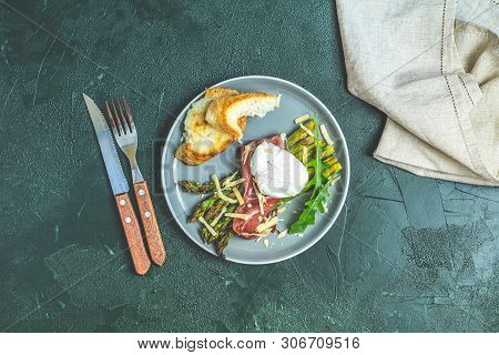 Green Asparagus And Boiled Poached Egg With Hamon (jamon) And Chopped Parmigiano (parmesan) On A Dar