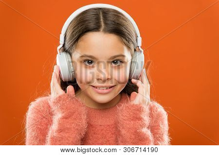 Modern Music Is Her Life Style And Pleasure. Little Modern Girl Wearing Bluetooth Headphones. Small 