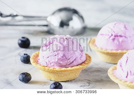 Violet Fruit Ice Cream Dessert In Waffle Bowl. Three Portion Of Ice-cream In Basket With Metal Spoon