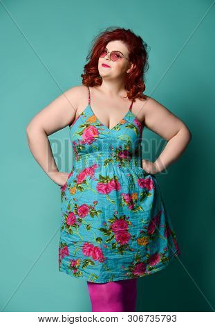 Pretty Plus-size Fat Woman Stands Like A Mom In Front Of Kids With Hands On Her Hips And Looks At Us