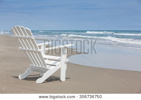 Empty White Wooden Chair At A Paradisiac Beach On The Tropics In A Beautiful Sunny Day