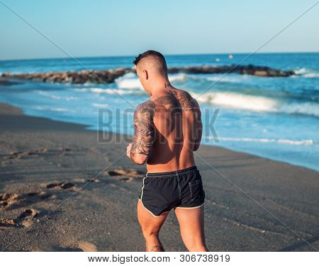 Tattooed Bodybuilder Sexy Male Coach At The Beach.