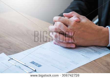 Senior Manager Reading A Resume During A Job Interview Employee Young Man Meeting Applicant And Recr