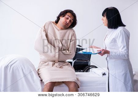 Old female psychiatrist visiting young male patient 
