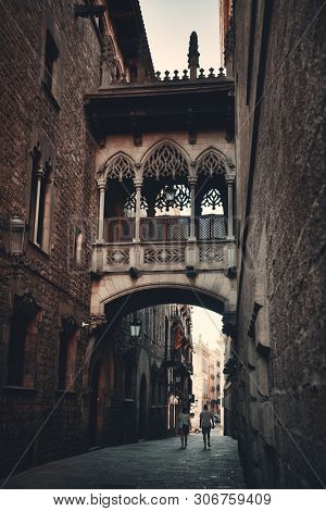 Pont del Bisbe and narrow street in Gothic Quarter in Barcelona Spain